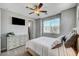 Inviting bedroom featuring a mounted TV, natural light, and neutral color palette at 8958 Howell St, Las Vegas, NV 89166