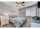 Comfortable bedroom with ceiling fan, bedside table, and natural light from the window at 8958 Howell St, Las Vegas, NV 89166