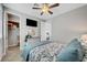 Cozy bedroom featuring a ceiling fan, mounted television, and ample closet space at 8958 Howell St, Las Vegas, NV 89166