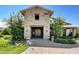 Beautiful clubhouse exterior with stone facade, well-maintained landscaping and brick-paved driveway on a sunny day at 8958 Howell St, Las Vegas, NV 89166