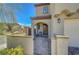 Private front courtyard entry complete with wrought iron gate and archway leading to covered front porch at 8958 Howell St, Las Vegas, NV 89166