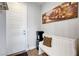 Welcoming foyer with a bench, decorative painting, and a water cooler for convenience at 8958 Howell St, Las Vegas, NV 89166