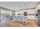 Bright, modern kitchen with a large island, pendant lighting, and stainless steel appliances at 8958 Howell St, Las Vegas, NV 89166