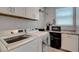 Well-equipped laundry room with modern washer, dryer, and storage cabinets at 8958 Howell St, Las Vegas, NV 89166