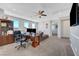 Spacious living room features a comfortable seating area, desk, and natural light with neighborhood views at 8958 Howell St, Las Vegas, NV 89166