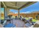 Relaxing outdoor patio with comfortable seating, ceiling fan, and views of the backyard at 8958 Howell St, Las Vegas, NV 89166