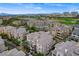An aerial scene features a condo community near a golf course, set against a skyline of mountains and city structures at 9201 Tesoras Dr # 401, Las Vegas, NV 89144