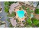 Overhead aerial of the private community pool, showcasing desert landscaping with mature palm trees and lounge seating at 9201 Tesoras Dr # 401, Las Vegas, NV 89144