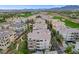 This aerial view shows townhouses, mountains, golf courses, and other features of the community at 9201 Tesoras Dr # 401, Las Vegas, NV 89144
