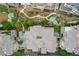 Aerial top-down view of condos, showcasing walkways, desert landscaping with mature trees, and private community pools at 9201 Tesoras Dr # 401, Las Vegas, NV 89144