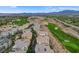 Nevada homes sit along a lush green golf course set against a backdrop of desert landscape and mountain views at 9201 Tesoras Dr # 401, Las Vegas, NV 89144