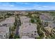 An aerial shot displays a condo complex close to golf course and hotel with a backdrop of mountains and an expansive sky at 9201 Tesoras Dr # 401, Las Vegas, NV 89144