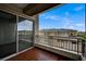 Balcony with wood floors and sliding glass doors overlooking neighborhood at 9201 Tesoras Dr # 401, Las Vegas, NV 89144