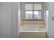Bright bathroom featuring a drop-in bathtub with natural lighting from a window at 9201 Tesoras Dr # 401, Las Vegas, NV 89144