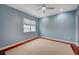 This bedroom features a ceiling fan, carpet, a window with a shade, and light blue paint at 9201 Tesoras Dr # 401, Las Vegas, NV 89144