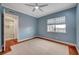 This bedroom has carpeted floors, a window, and a ceiling fan; there is also a bathroom with a towel rack at 9201 Tesoras Dr # 401, Las Vegas, NV 89144