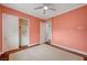 Bedroom features neutral carpet, a ceiling fan, closet, and multiple access doors at 9201 Tesoras Dr # 401, Las Vegas, NV 89144