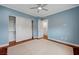 This bedroom has hardwood floors, a ceiling fan, a window, a closet, and a door to another room at 9201 Tesoras Dr # 401, Las Vegas, NV 89144