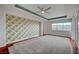 Large bedroom with wallpapered accent wall, hardwood floors, and carpet at 9201 Tesoras Dr # 401, Las Vegas, NV 89144