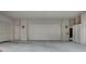 This garage has two garage doors, concrete floors, and white paint at 9201 Tesoras Dr # 401, Las Vegas, NV 89144