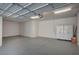 This garage has an epoxy floor, storage cabinets, recessed lighting, and white paint at 9201 Tesoras Dr # 401, Las Vegas, NV 89144