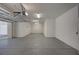 This empty garage features an epoxy floor, lighting, and white walls at 9201 Tesoras Dr # 401, Las Vegas, NV 89144