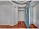 Hallway with hardwood floors, closet and view of the entry door with decorative trim at 9201 Tesoras Dr # 401, Las Vegas, NV 89144