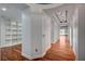 Hallway featuring hardwood floors, built-in shelving, and recessed lighting at 9201 Tesoras Dr # 401, Las Vegas, NV 89144