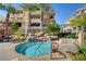 Community hot tub with stone surround, landscaping, and building exterior in background at 9201 Tesoras Dr # 401, Las Vegas, NV 89144