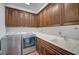 Laundry room with washer, dryer, sink, and wooden cabinets at 9201 Tesoras Dr # 401, Las Vegas, NV 89144