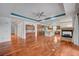 Open-concept living space with fireplace, hardwood floors, and views of kitchen at 9201 Tesoras Dr # 401, Las Vegas, NV 89144