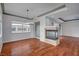 Sun-filled living room featuring a stone fireplace and hardwood floors at 9201 Tesoras Dr # 401, Las Vegas, NV 89144
