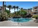 Enjoy the community pool with lush landscaping, palm trees and lounge chairs on the deck at 9201 Tesoras Dr # 401, Las Vegas, NV 89144