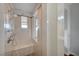 Shower with multiple shower heads, a built-in seat, and a glass partition at 9201 Tesoras Dr # 401, Las Vegas, NV 89144
