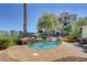 Beautifully landscaped backyard with a spa, small trees and patio furniture at 9201 Tesoras Dr # 401, Las Vegas, NV 89144
