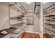 Well-organized walk-in closet with shelving and dark wood floors at 9201 Tesoras Dr # 401, Las Vegas, NV 89144