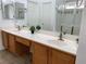 Bathroom featuring double sinks, a large mirror, and a glass-enclosed shower at 9236 Canalino Dr, Las Vegas, NV 89134