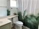 Bathroom with a white toilet, white-painted vanity, and a decorative shower curtain at 9236 Canalino Dr, Las Vegas, NV 89134