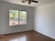Bedroom showcasing ceiling fan, wood-look flooring, neutral walls, and a large window at 9236 Canalino Dr, Las Vegas, NV 89134