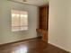 Bedroom showcasing wood floor, window with shades, and built-in wood desk and shelves at 9236 Canalino Dr, Las Vegas, NV 89134