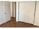Bedroom with wood flooring, a closet with sliding doors, and a white painted door at 9236 Canalino Dr, Las Vegas, NV 89134