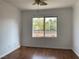 Bedroom featuring wood-look floors, white walls, and a large window with views at 9236 Canalino Dr, Las Vegas, NV 89134