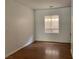 Bedroom with wood floor, baseboards, window with light-blocking shades, and neutral-colored walls at 9236 Canalino Dr, Las Vegas, NV 89134
