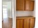 Hallway featuring wood-look floors and wooden cabinets and pantry at 9236 Canalino Dr, Las Vegas, NV 89134