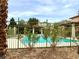Community pool area surrounded by desert landscaping and trees, offering a relaxing and private experience at 9236 Canalino Dr, Las Vegas, NV 89134