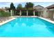 A beautiful community pool with lounge chairs and shaded pergola, perfect for relaxation and recreation at 9236 Canalino Dr, Las Vegas, NV 89134