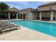 Community pool area with several lounge chairs and shaded pergola, perfect for relaxation and recreation at 9236 Canalino Dr, Las Vegas, NV 89134