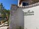 Community signage with stone accent wall, featuring manicured landscaping, and clearly marking the entrance at 9236 Canalino Dr, Las Vegas, NV 89134