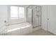 Bathroom with bathtub, glass shower, and window for natural lighting at 9247 Tulip Trestle Ave, Las Vegas, NV 89148