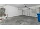Spacious two-car garage with white walls and concrete floor, offering ample space for parking and storage at 9247 Tulip Trestle Ave, Las Vegas, NV 89148
